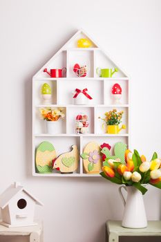 House shelves on a wall - Easter decorations for holiday