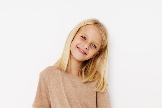 Little cute girl in a beige t-shirt lifestyle concept. High quality photo