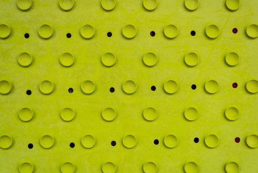 Rubber light green old cracked bath mat with holes and suction cups.