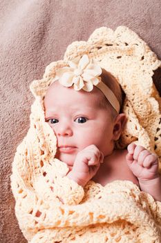 Newborn baby girl on the crochet blanket