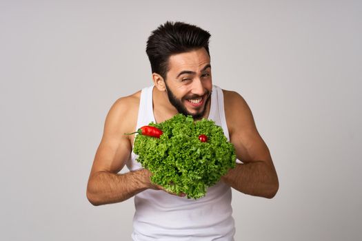 bearded man in white t-shirt lettuce leaf vegetables healthy food. High quality photo