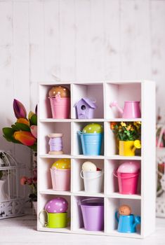 Colourful Eggs in miniature buckets and cans in shadowbox. Spring and Easter decor
