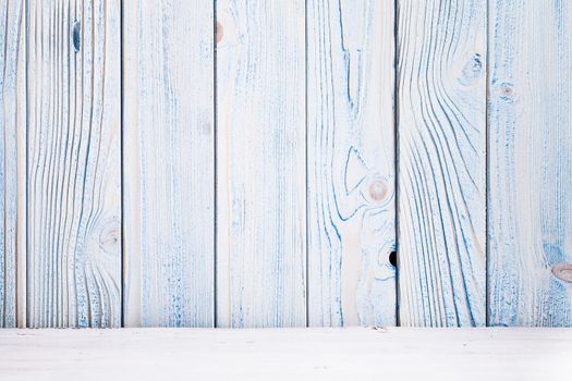 Blue wooden wall, painted in shabby chic style and white floor