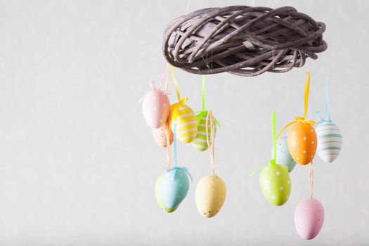 Easter wreath with color eggs on ribbons