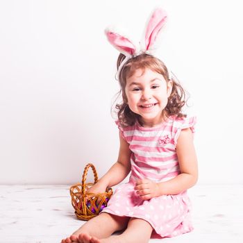 Girl eats a chocolate little eggs after Easter hunting