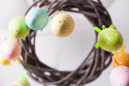 Easter wreath with color eggs on ribbons