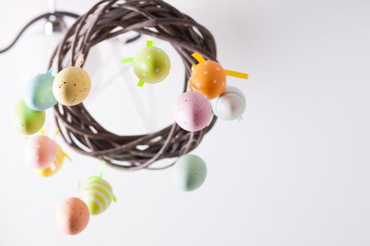 Easter wreath with color eggs on ribbons