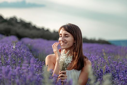 Lavender flower blooming scented fields in endless rows. Selective focus on Bushes of lavender purple aromatic flowers at lavender field. Abstract blur for background.