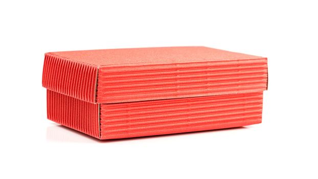 Red closed corrugated cardboard box isolated on white. Valentine's Day gift packaging concept