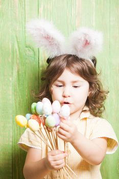 Girl with bunny ears and little eggs. Easter celebration