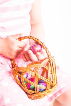 Girl hold a chocolate little egg after Easter hanting