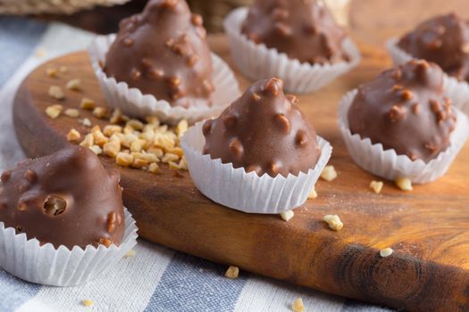 Small chocolate sweets with nuts close up. Dessert