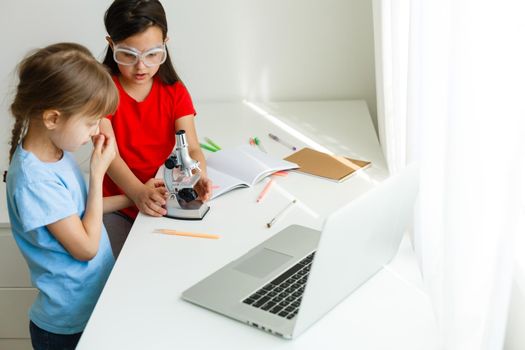 Learning from home, Home school kid concept. Little children study online learning from home with laptop. Quarantine and Social distancing concept.