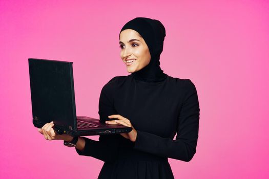 cheerful muslim woman with laptop education student internet technology. High quality photo