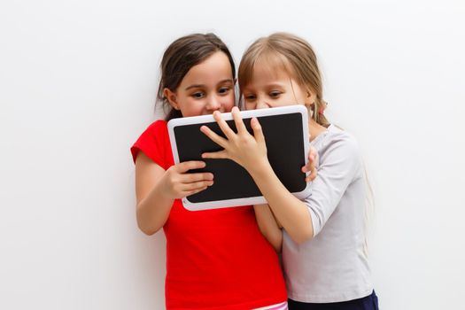 picture of two beautiful girls with tablet pc on white background