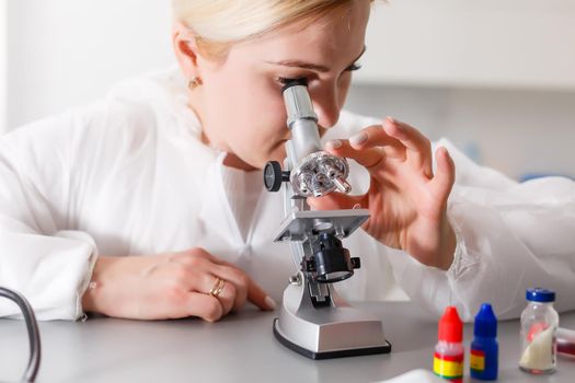 Woman working with a microscope in lab