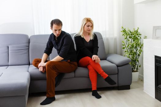 Sad unhappy young couple talking with psychologist in psychologist office