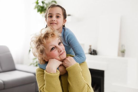 Grandmother and granddaughter portrait, embraced