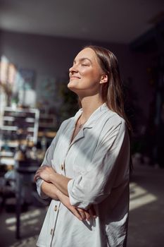 Young caucasian happy seller woman at botanic shop