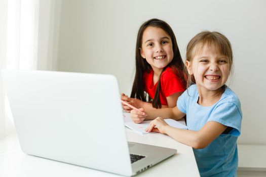 Pretty stylish schoolgirls studying math during her online lesson at home, social distance during quarantine, self-isolation, online education concept