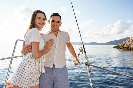 Happy couple in love on a yacht in summer on romantic vacation