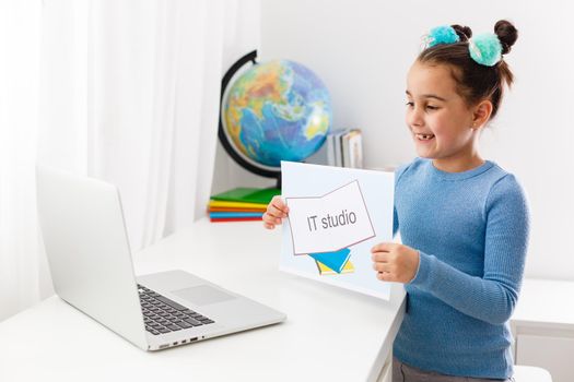 Online distance learning at home during quarantine. lilittle girl studying it on laptop online