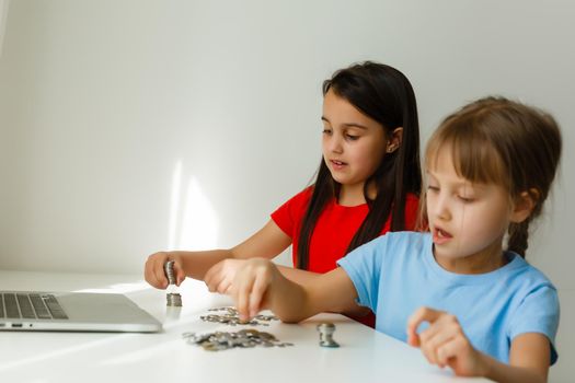 Two kids counting coins together