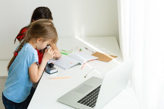 Learning from home, Home school kid concept. Little children study online learning from home with laptop. Quarantine and Social distancing concept.