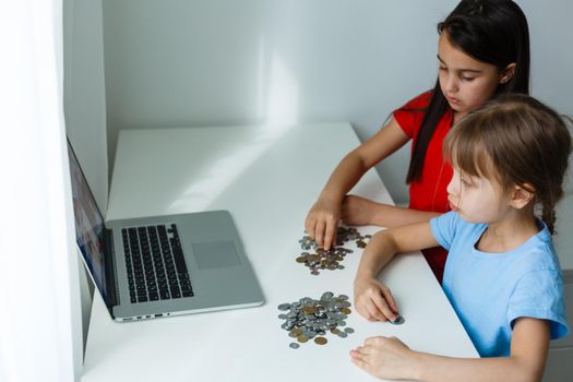 Two kids counting coins together