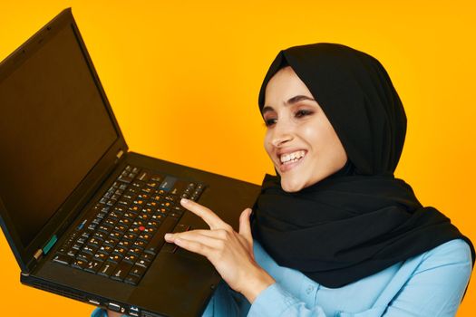 woman in black hijab laptop posing technology internet isolated background. High quality photo