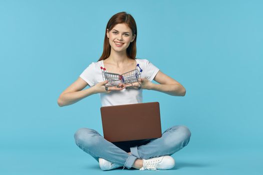 woman with laptop learning internet online education blue background. High quality photo