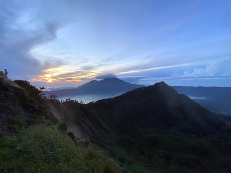 Hiking around the crater of Mount Batur with Mount Agung in the background