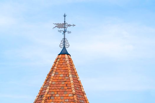 the tower of an old castle with a weather vane. High quality photo
