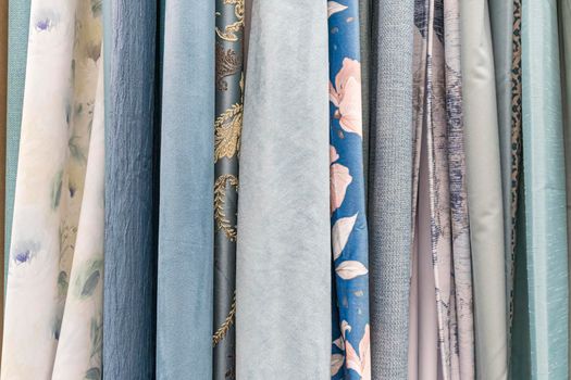 multicolored textures of fabrics on the shelves of stores close-up. High quality photo