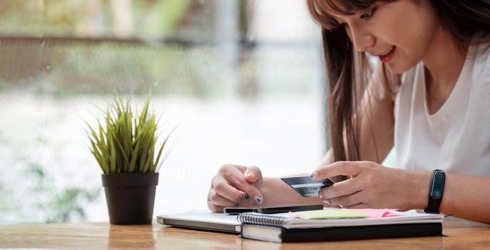 Woman use mobile phone for shopping online with credit card.