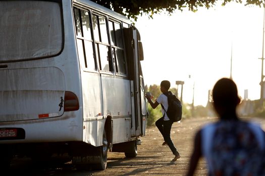 santo antonio de jesus, bahia, brazil - august 7, 2019: public school students are seen along the school transport bus in the street area in the city of Santo Antonio de Jesus.