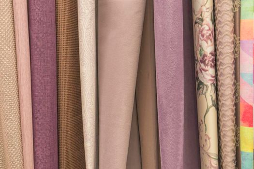 multicolored textures of fabrics on the shelves of stores close-up. High quality photo