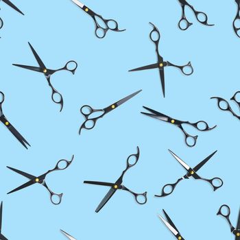 Seamless pattern of black scissors. professional hairdresser black scissors isolated on blue. Black barber scissors, close up. pop art background, for prints or posters