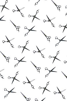 Background of black scissors. professional hairdresser black scissors isolated on white. Black barber scissors, close up. pop art background, for prints or posters. not seamless pattern