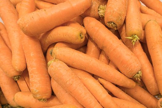 ripe delicious carrots close up as a background. High quality photo