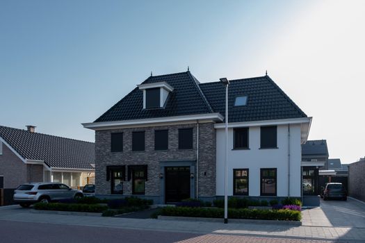 Dutch Suburban area with modern family houses, newly build modern family homes in the Netherlands, dutch family house, apartment house. Netherlands