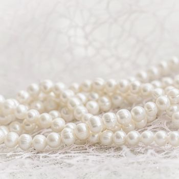 Nature white string of pearls in soft focus, with highlights.