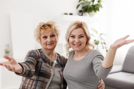 Self portrait of charming pretty stylish positive cheerful mom and adult child shooting selfie on front camera gesturing v-sign with two fingers isolated on grey background rest relax leisure concept