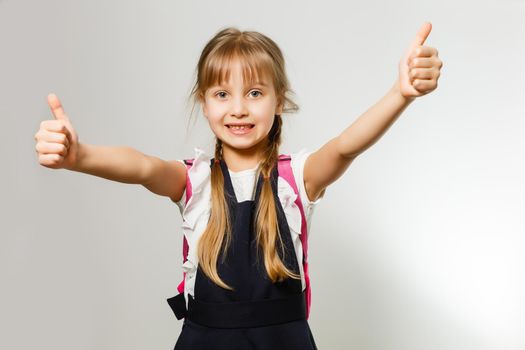 little blond school girl with backpack bag portrait isolated on white background