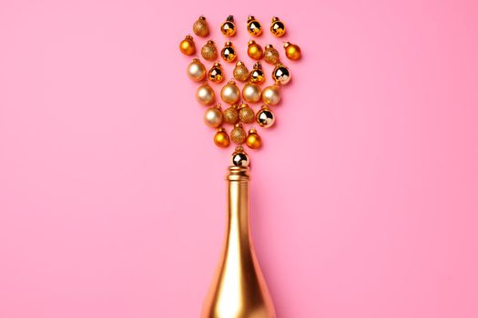 Flat lay composition with gold champagne bottle and Christmas balls top view