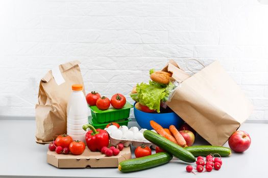 Different set of products to order in paper bags on white background