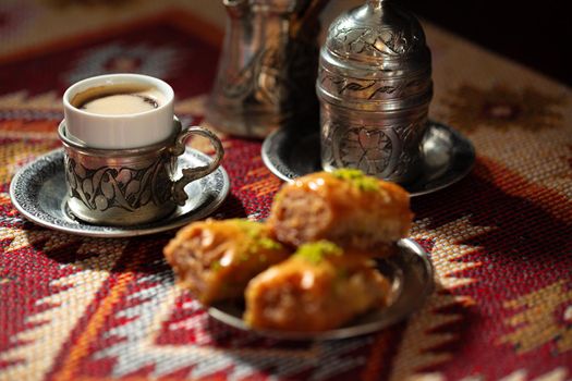 Small cup of Turkish coffee and Turkish baklava on table