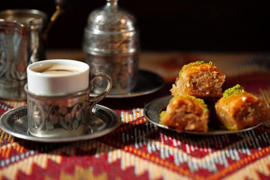 Small cup of Turkish coffee and Turkish baklava on table