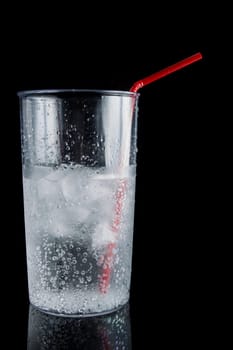 ice and soda in a glass cup - closeup