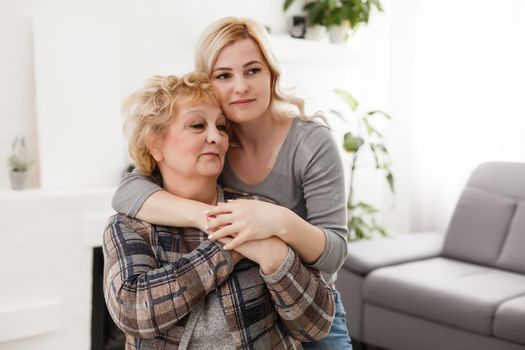 happy senior mother and adult daughter closeup portrait at home